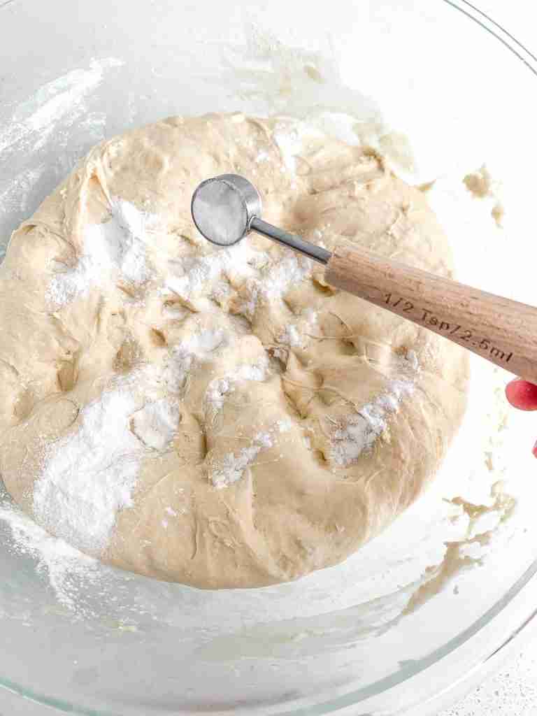 adding baking powder and soda to sourdough maple cinnamon roll dough