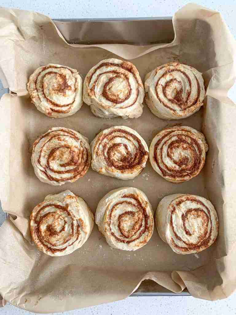 shaped sourdough maple cinnamon rolls in a pan