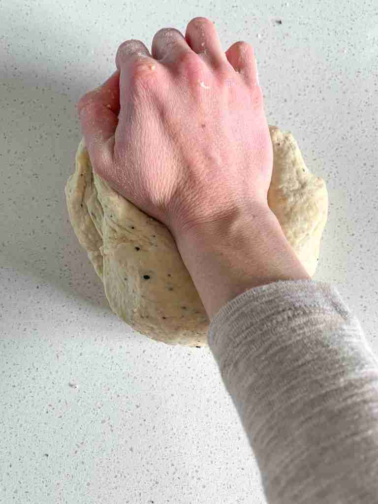 kneading sourdough everything bagel dough