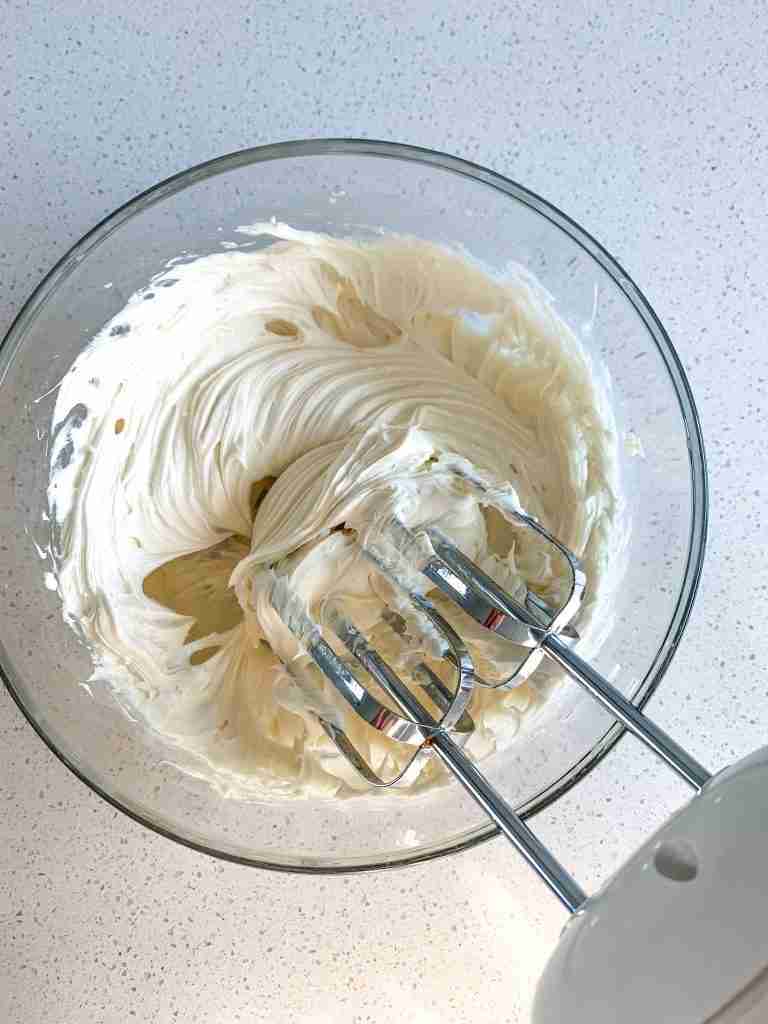 making maple frosting for sourdough maple cinnamon rolls