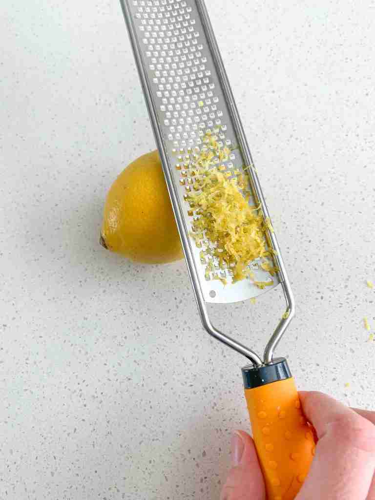 zesting a lemon for lemon poppyseed muffins