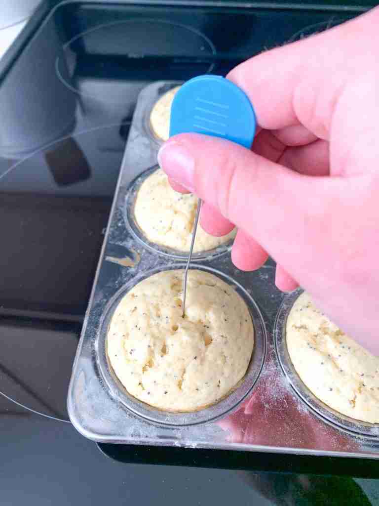 testing lemon poppyseed muffins to see if they're done baking