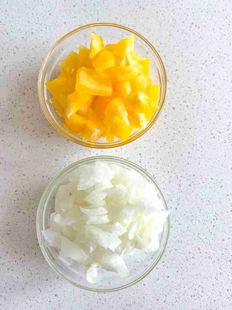bell pepper and onion diced and in bowls to make mexican chicken and rice soup