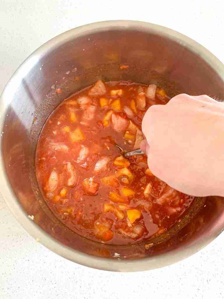 stirring ingredients in a pan to make mexican chicken and rice soup