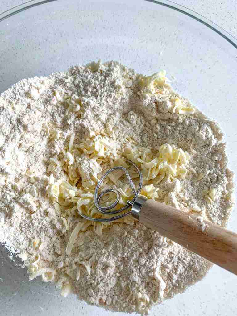 mixing butter into flour mixture to make sourdough orange scones
