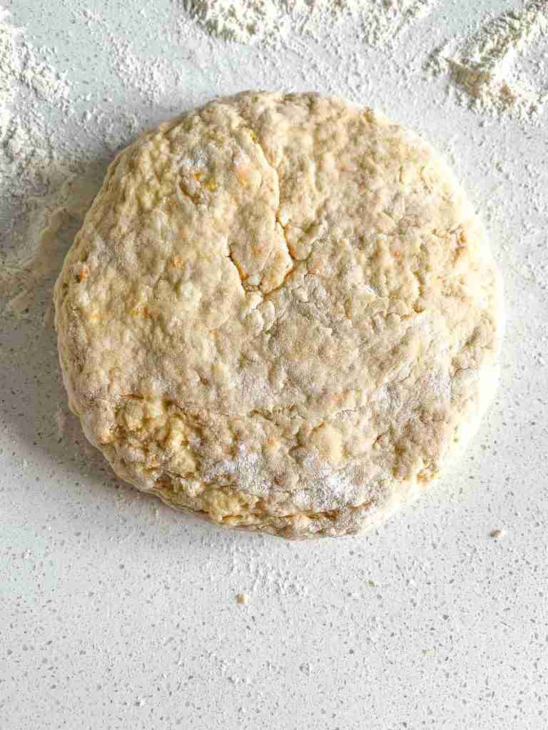 sourdough orange scone dough shaped into a disk