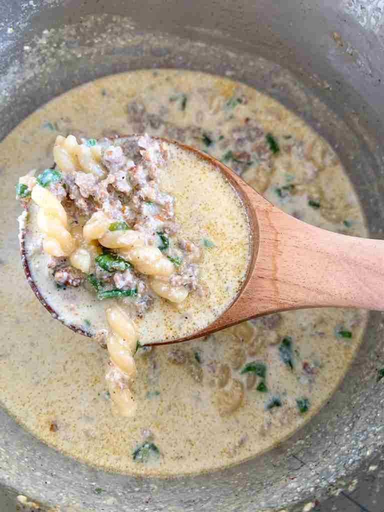 freshly cooked Creamy Parmesan Italian Sausage Soup in a ladle
