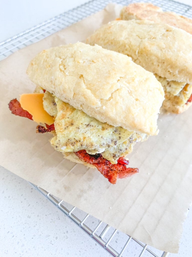 sourdough breakfast sandwich with buttermilk biscuits, eggs, cheese, and bacon