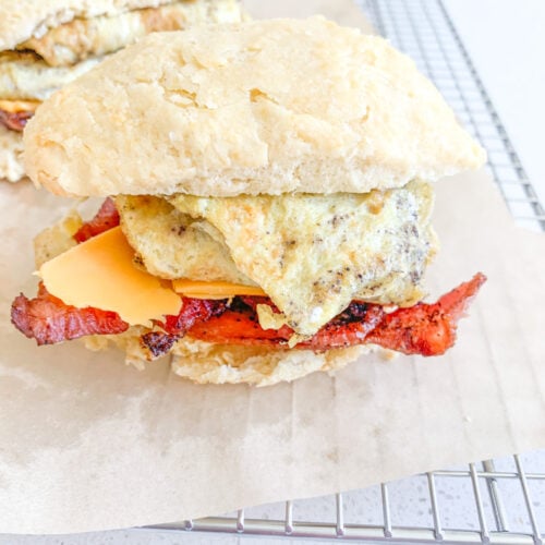 sourdough breakfast sandwich with buttermilk biscuits, eggs, cheese, and bacon
