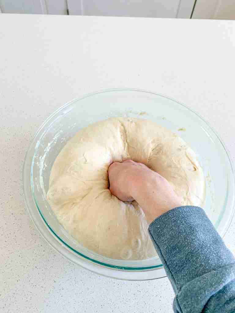 punching down sourdough garlic pull apart bread dough