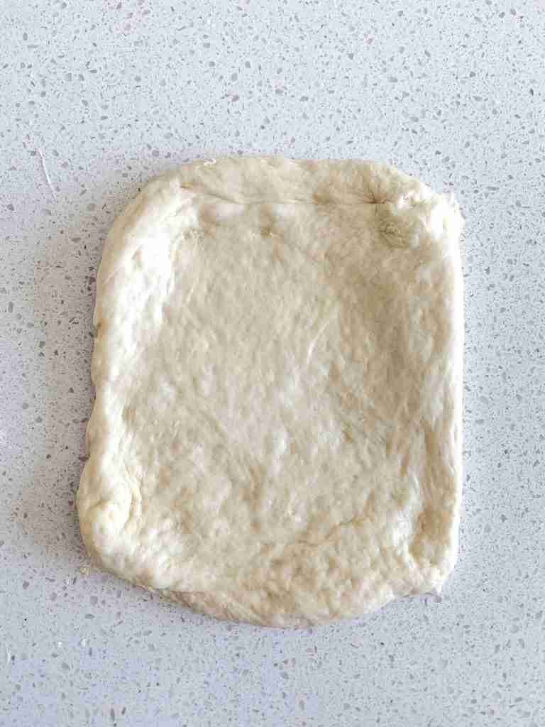 rolled out sourdough garlic pull apart bread dough