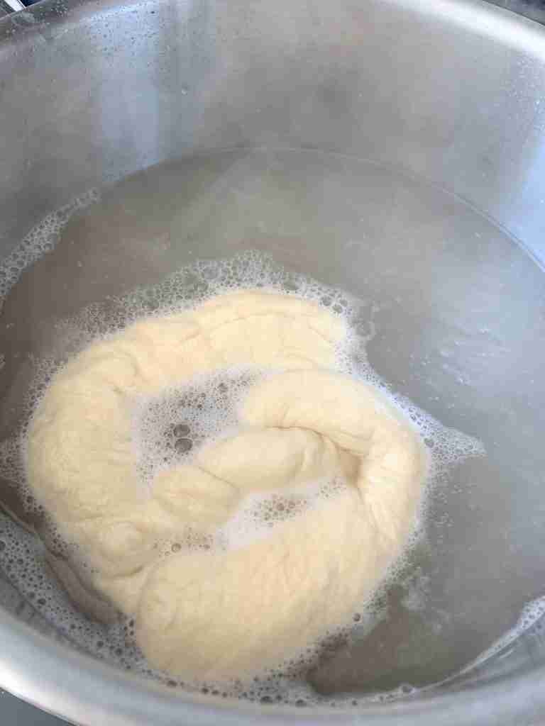 soft sourdough pretzel getting boiled