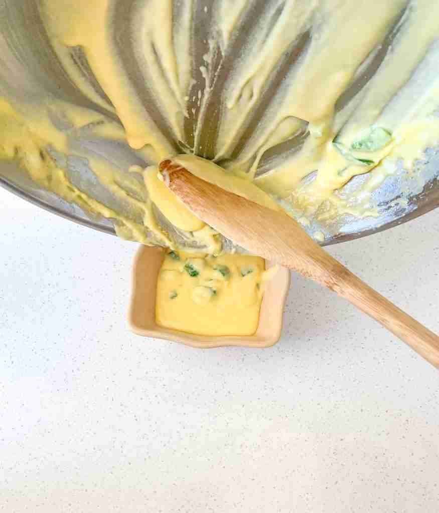 pouring freshly made for jalapeno cheese dip into a bowl
