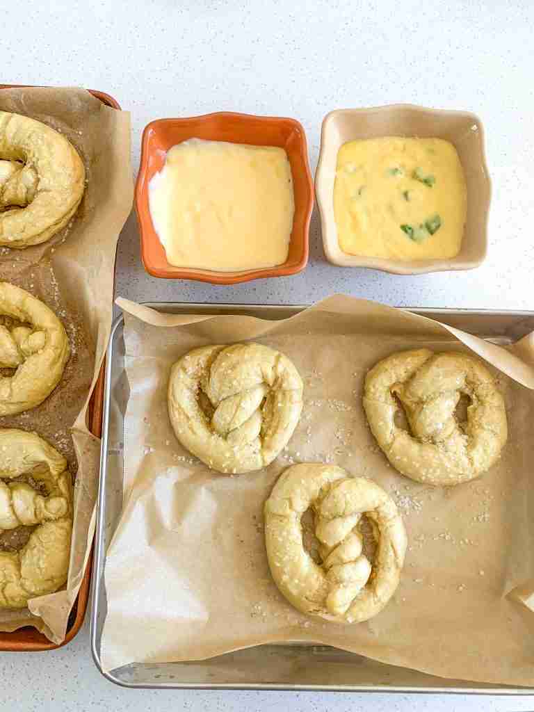 freshly baked and salted sourdough soft pretzels and cheese dipping sauces