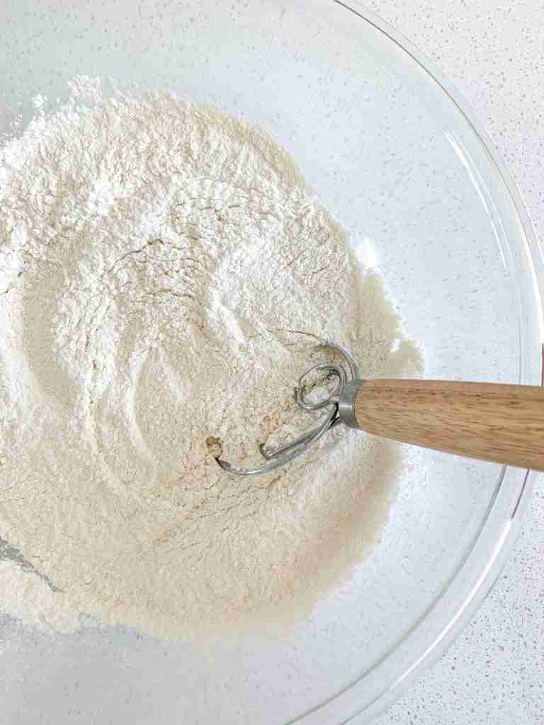 mixing dry flour mix for sourdough breakfast sandwiches