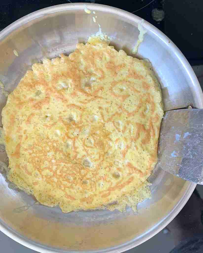 cooking eggs for sourdough breakfast sandwiches