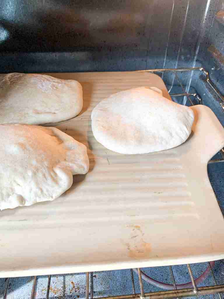 sourdough pita bread baking in the oven