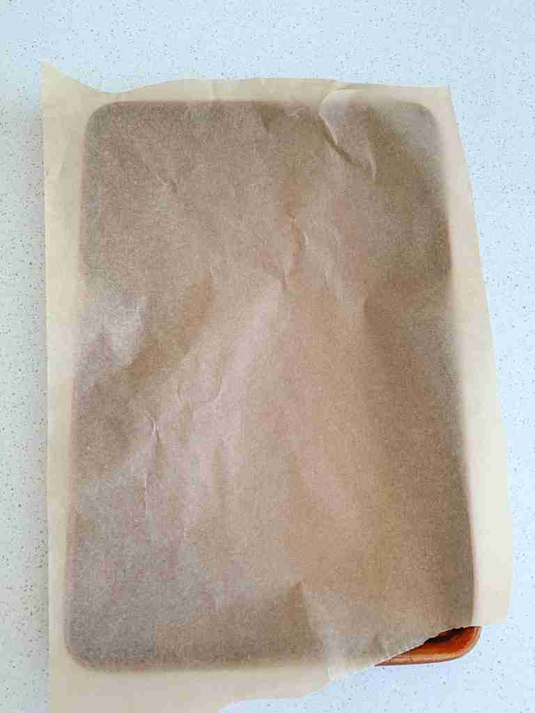 sheet pan lined with parchment paper for chicken shawarma sheet pan dinner