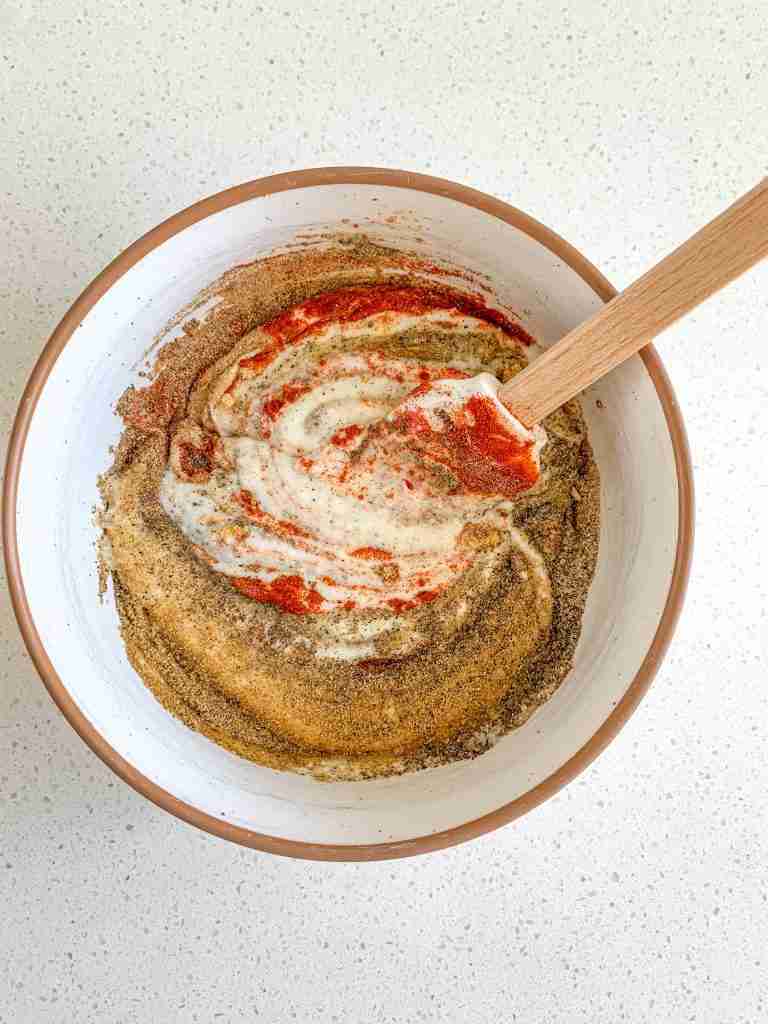 mixing spices and yogurt for chicken shawarma sheet pan dinner