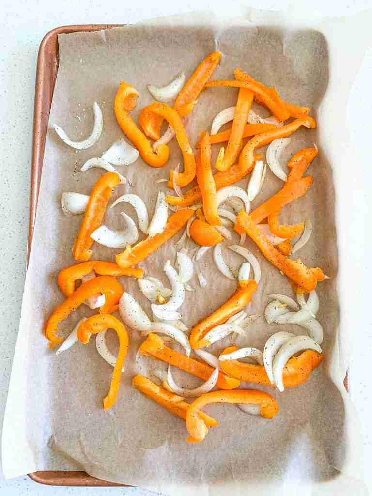 onions and peppers seasoned for chicken shawarma sheet pan dinner