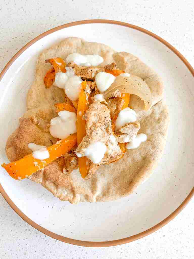 freshly cooked chicken shawarma sheet pan dinner served on a pita bread