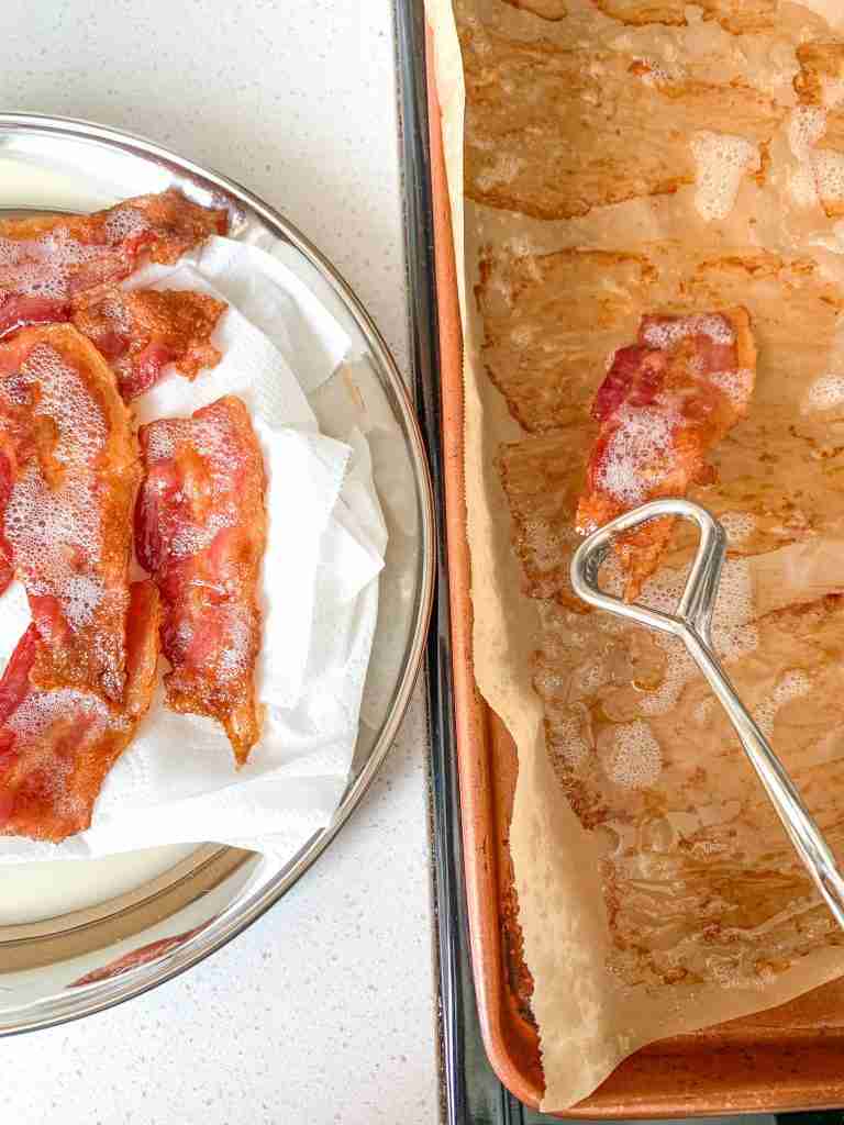 taking cooked bacon off pan for bacon cheese grits