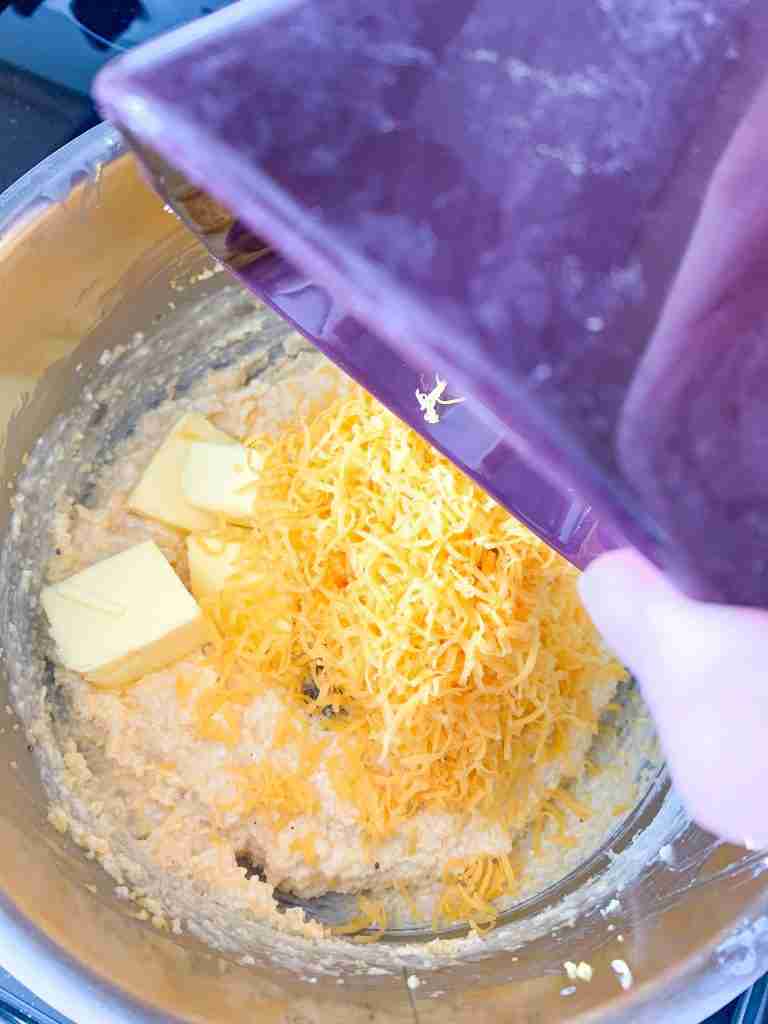 adding cheese into grits cooking