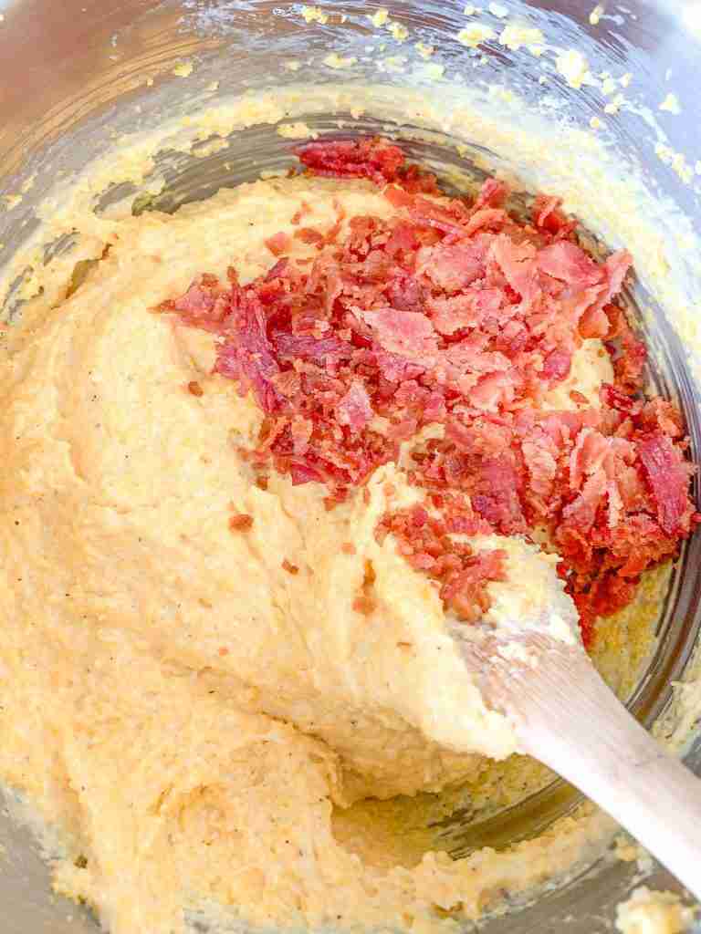 stirring bacon into bacon cheese grits