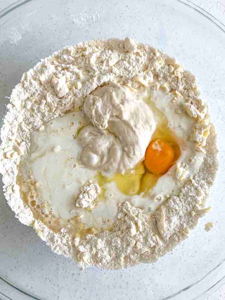 wet ingredients added into dry sourdough lemon scone mixture