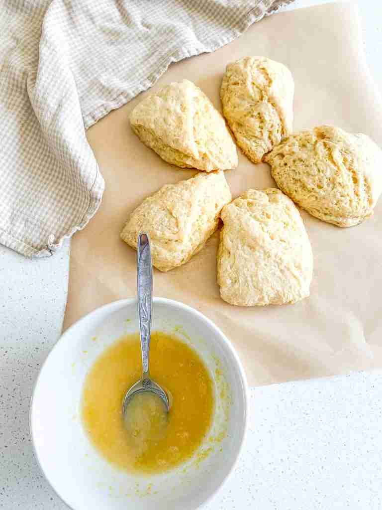 freshly baked sourdough lemon scones with glaze on the side