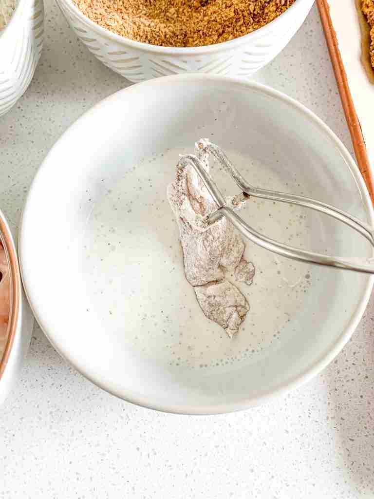 coating chicken in buttermilk for Buttermilk Fried Chicken Tenders