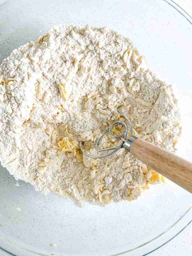 mixing butter into flour for sourdough chocolate chip walnut scones
