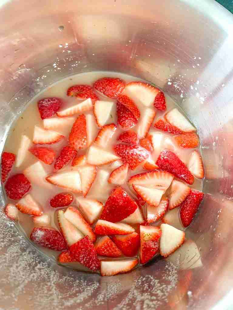 strawberry and sugar syrup in a pot for Homemade Strawberry Glaze (for Angel Food Cake)