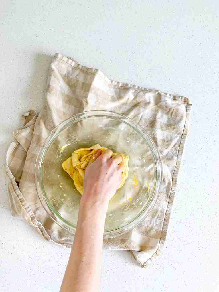 kneading egg into sourdough brioche bun dough