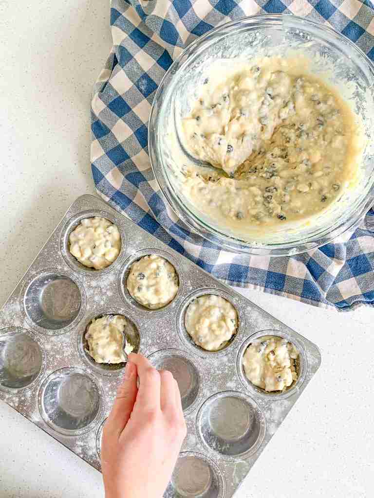 adding batter into muffin tin