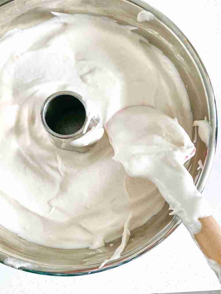 smoothing out sourdough angel food cake in pan
