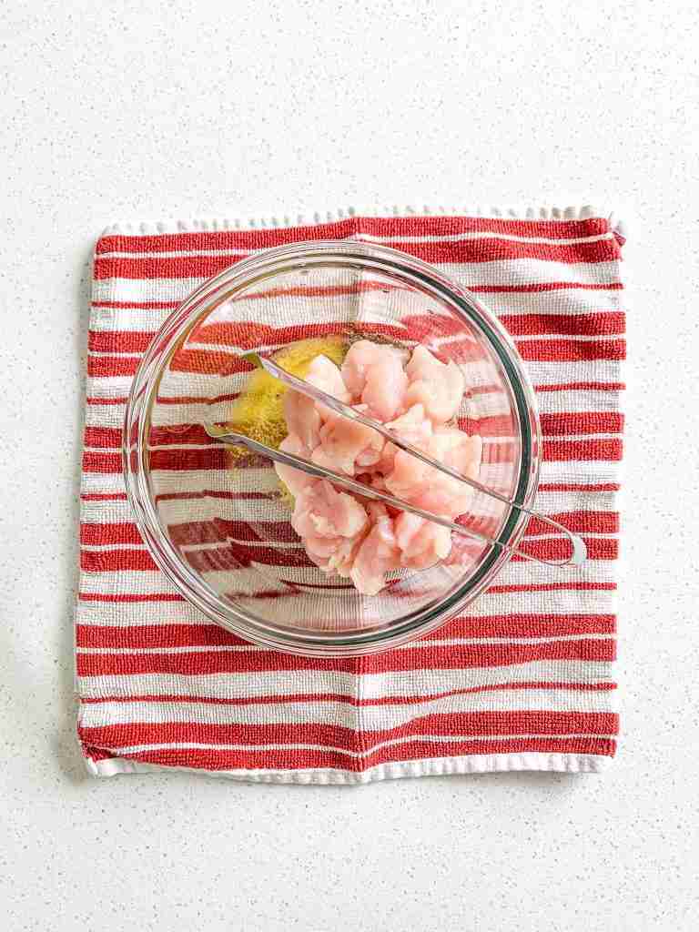 chicken and seasoning in a bowl