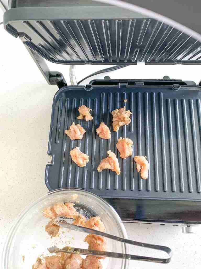 placing chicken on hot grill