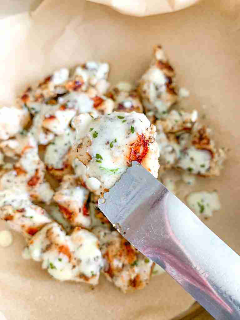 freshly cooked grilled chicken bites with creamy garlic sauce