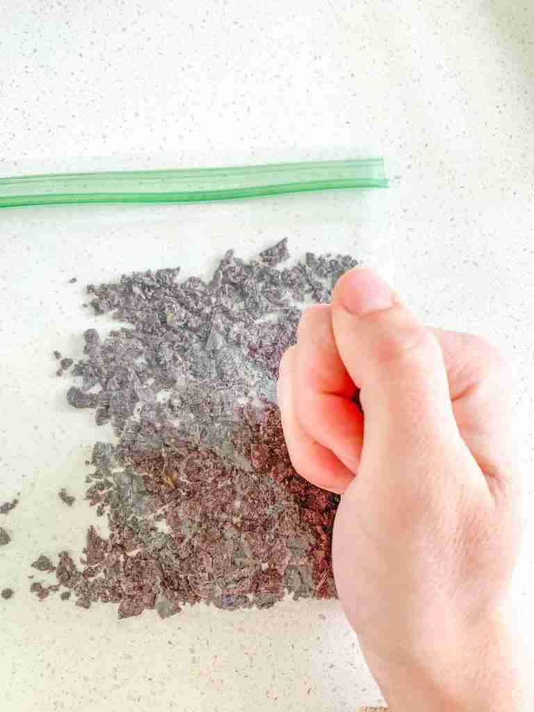 crushing blue corn tortilla chips for the dip