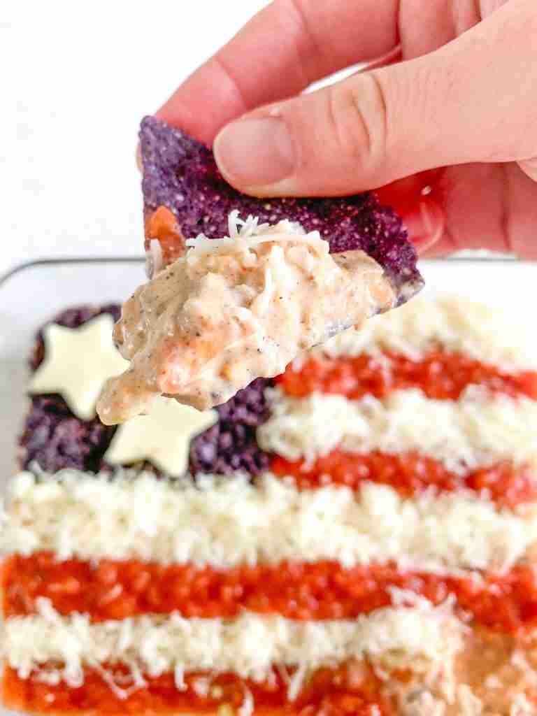 chip covered in freshly made dip