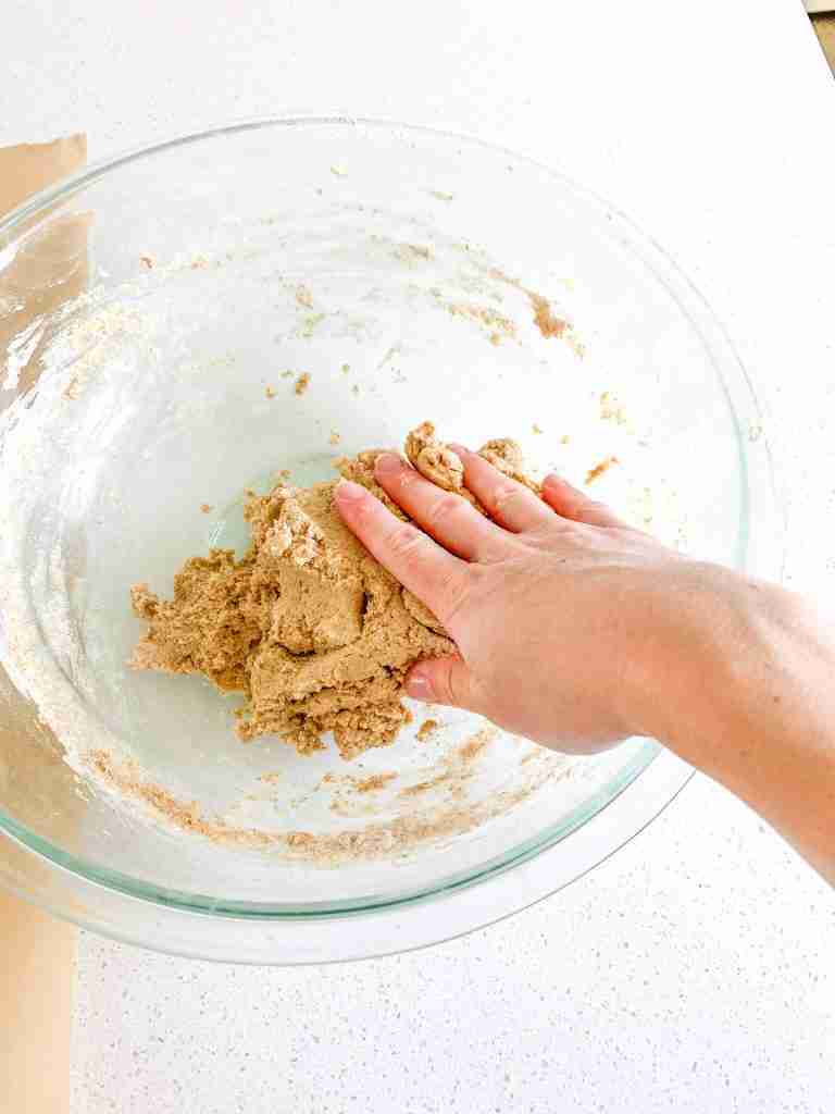 hand combining graham cracker dough