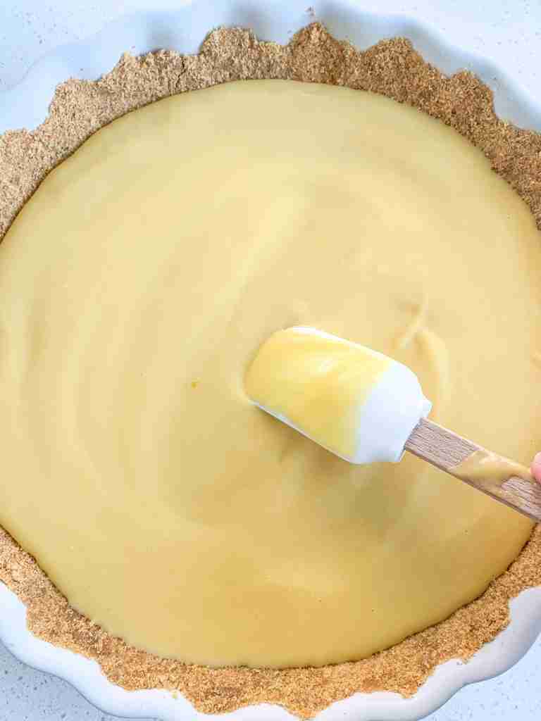 spreading peach curd out in a tart shell