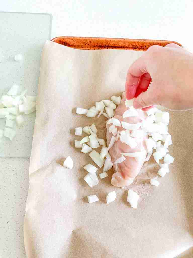 adding onions to sheet pan