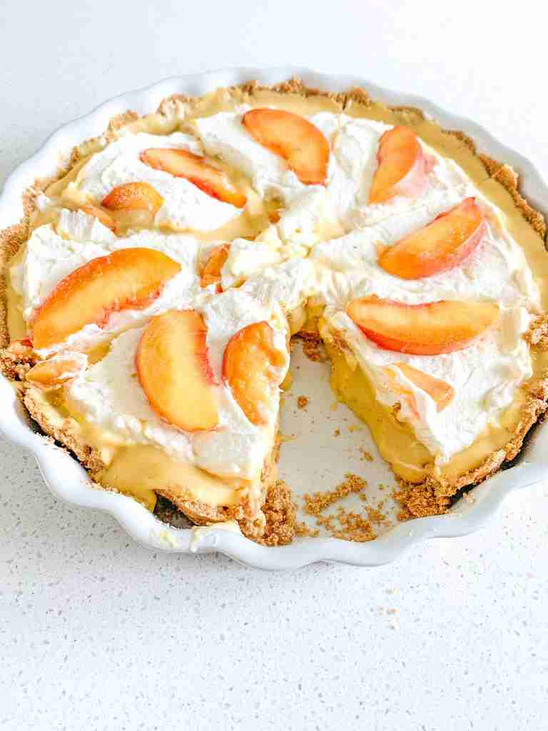freshly made icebox peach tart with a slice out