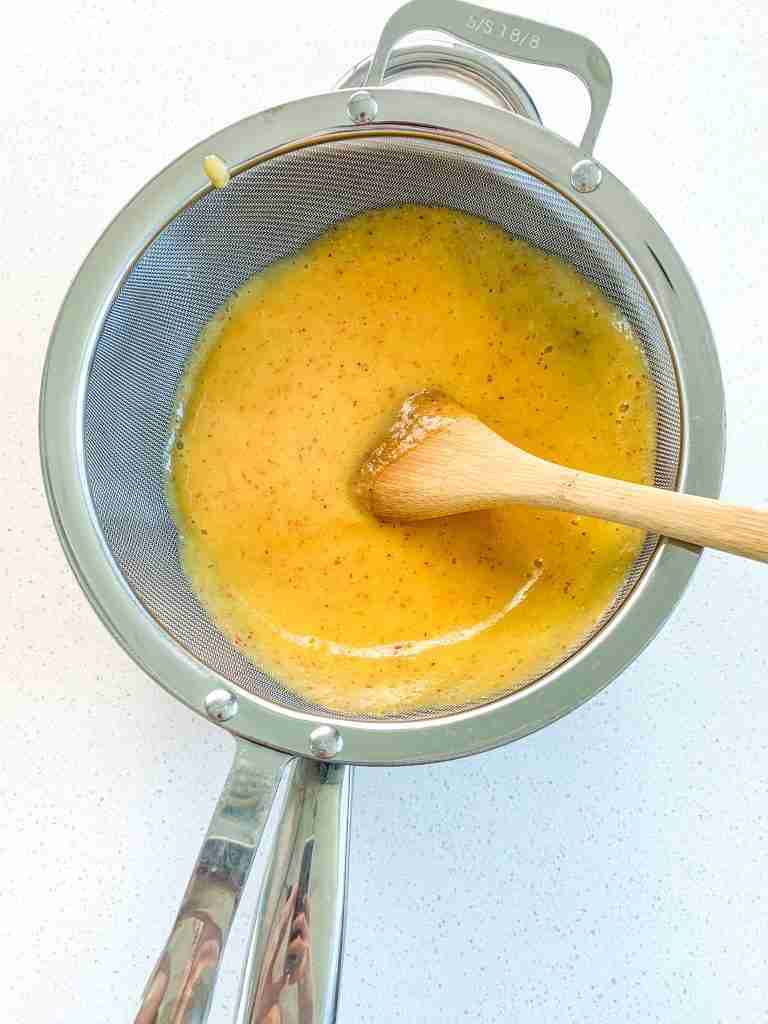 straining peach juice for the curd