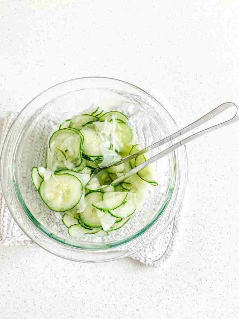 mixing cucumber and onion salad