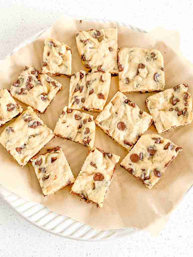 sourdough chocolate chip blondies squares on parchment covered plate