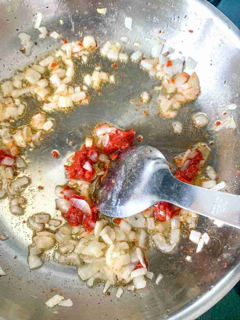cooking tomato paste in a skillet