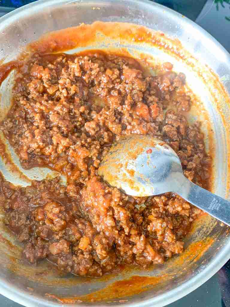 mixing beef into coney sauce